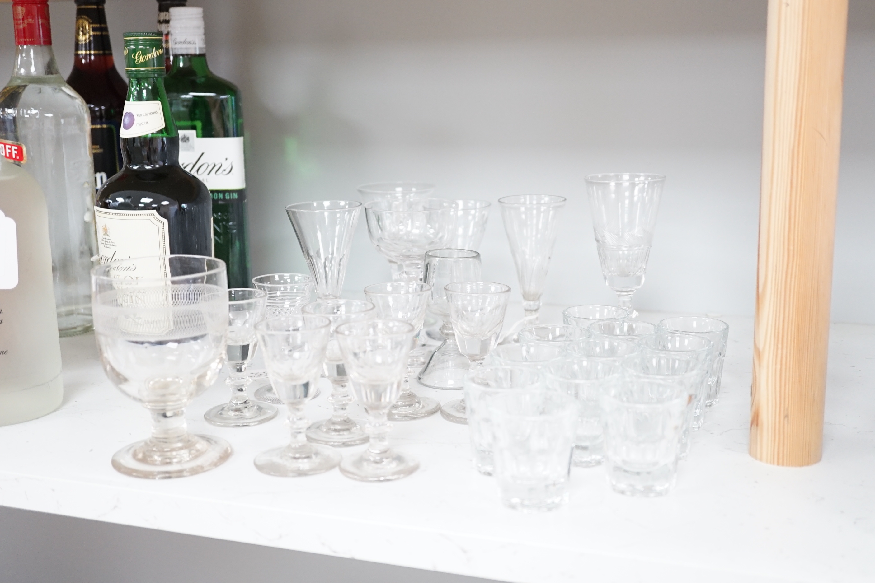A collection of early 19th to early 20th century drinking glasses, including a set of twelve shot glasses, a set of six liqueur glasses, plus nine other wine, gin and sherry glasses of various sizes, tallest 14.5cm (27)